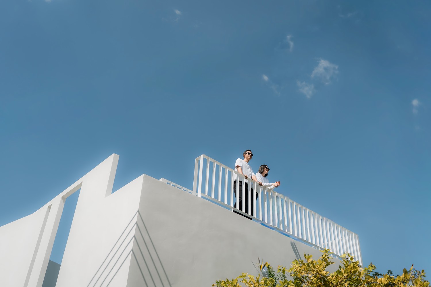 Wedding couple on a rooftop terrace against open sky